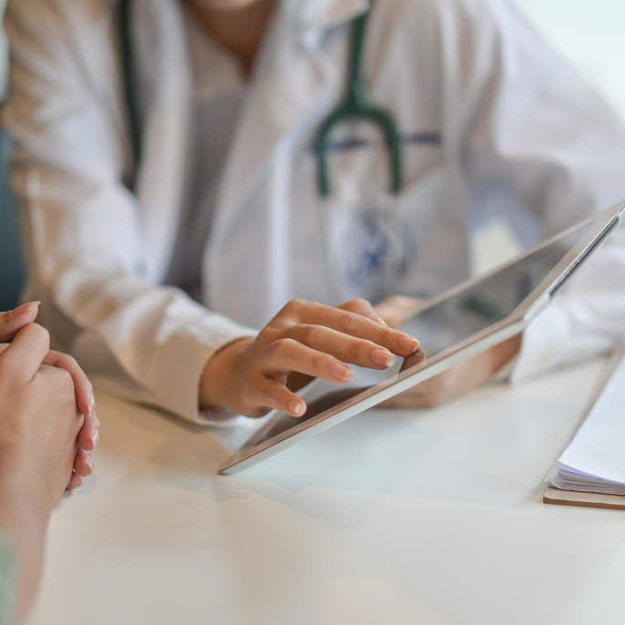 Doctor showing information on tablet